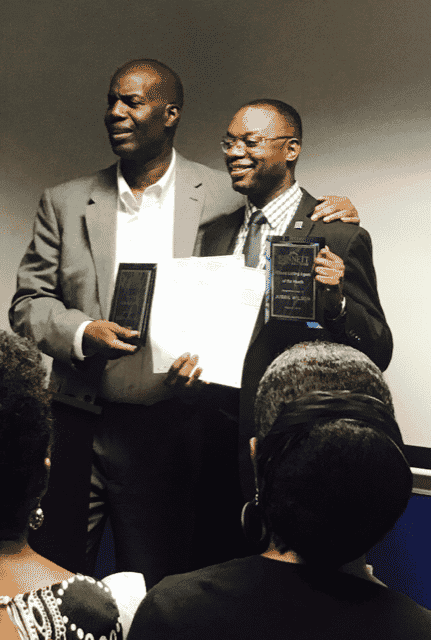 Jubril accepting an award at an event